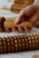 Een houten massage-instrument wordt gebruikt op de benen als onderdeel van een anti-cellulitis massage.