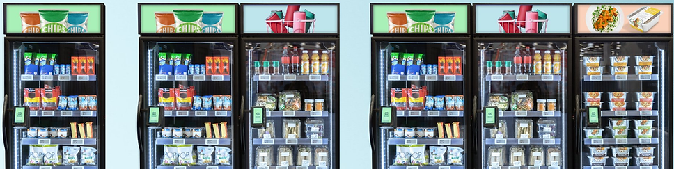 Five smart cooler units in a row, fully stocked with snacks, beverages, and fresh food