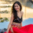 belly dancers is sitting in front of the water