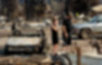 Among burned out cars and rubble from destroyed structures, a young woman cries next to her boyfriend as they take stock of the Dixie Fire's aftermath on their home.