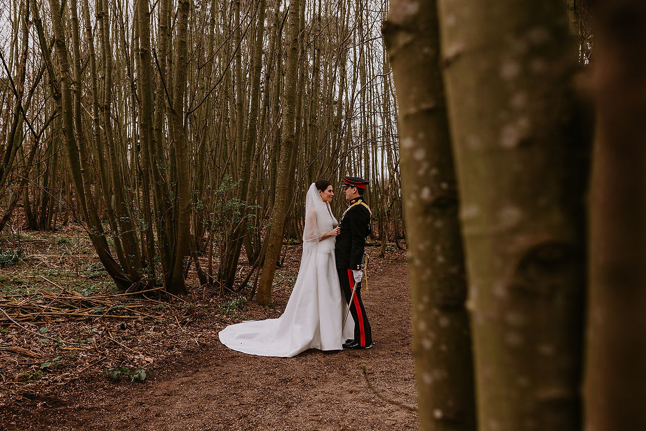 The bride and groom take a quiet moment together in the woodlands near Lodge Farm Weddings.