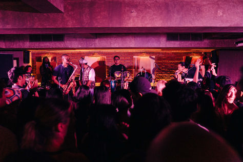 A crowd of audience watching a contemporary jazz band during an event called Offscript