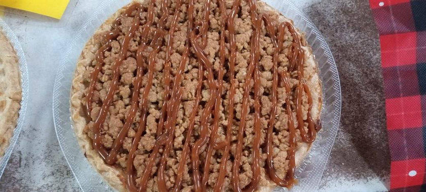 Delicious pie with caramel drizzle, a perfect dessert on a table.