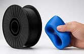 Premium studio product photography for modern 3D printing brand. Black TPU filament spool 