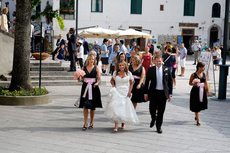 Bride and father of the bride together with bridesmaids walking to the church in Ravello Italy