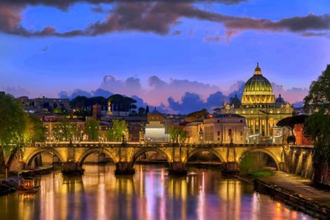 An overview over the Tiber River in Rome with St Peter's in the background.