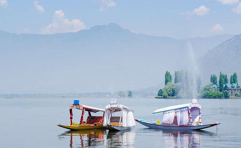 Drift along the shimmering waters of Kashmir in a Shikara, and let tranquility envelop your soul.