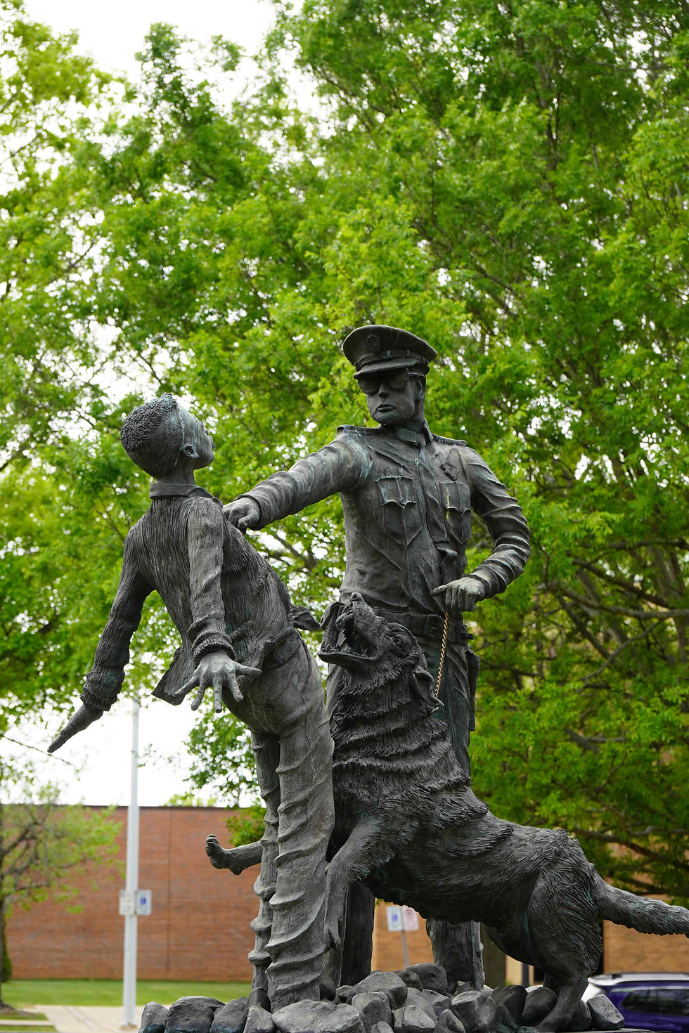 At Kelly Ingram Park, this sculpture captures one of the most searing images of the Civil Rights Movement: a young demonstrator confronted by a police officer and attack dog. Dedicated to the “foot soldiers” of Birmingham, the monument reflects the reality faced by children and citizens who met violence with courage. The inscription honors those who endured dogs, hoses, and bombings — not as symbols, but as participants in a struggle that reshaped American democracy. JavarJuarez©2026