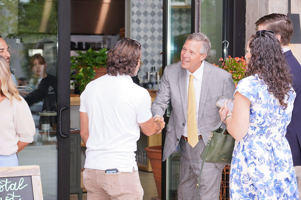 Columbia Mayor Daniel Rickenmann, right, shakes hands with Coastal Crust owner Brian Piesner as he welcomes him to the city before the ribbon cutting. JavarJuarez©2026