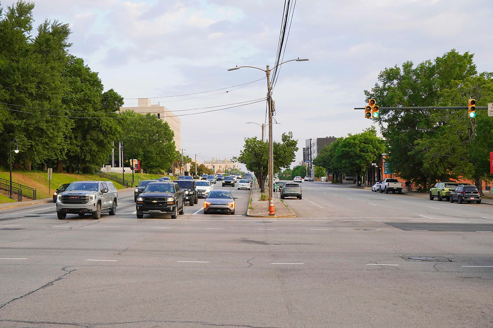 Looking south on Assembly Street toward USC, the corridor’s wide median and heavy traffic highlight the planned redesign, which removes median parking but maintains travel lanes while shifting parking to the sides. JavarJuarez©2026