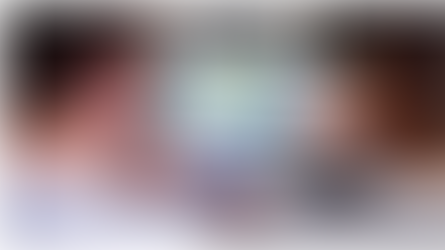 person looking phone and computer at real estate listings