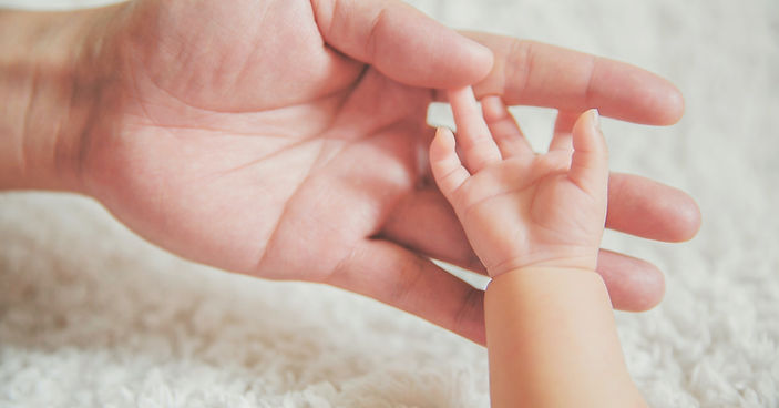 Mother holding newborn had