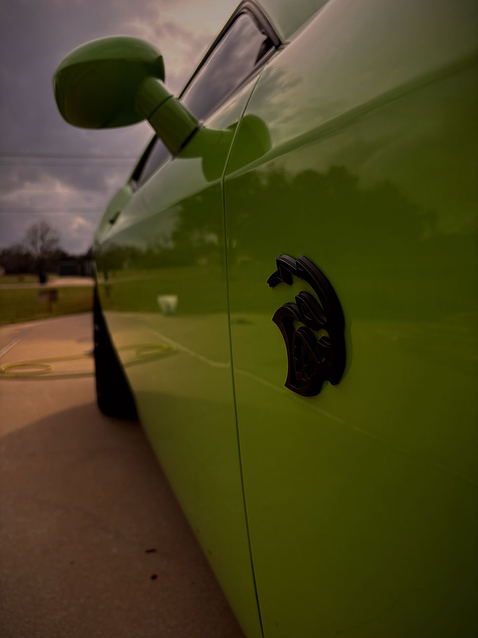 Close up of green Dodge muscle car paint showing high gloss finish from mobile detailing in Pearland Texas