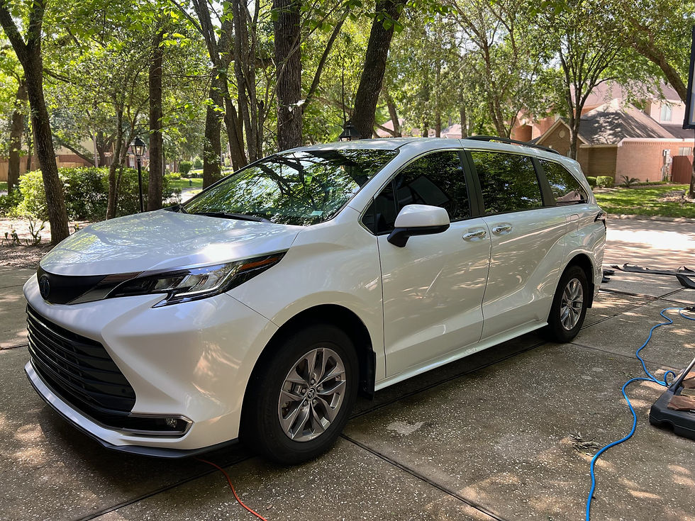 White Toyota Sienna minivan parked in driveway after exterior cleaning