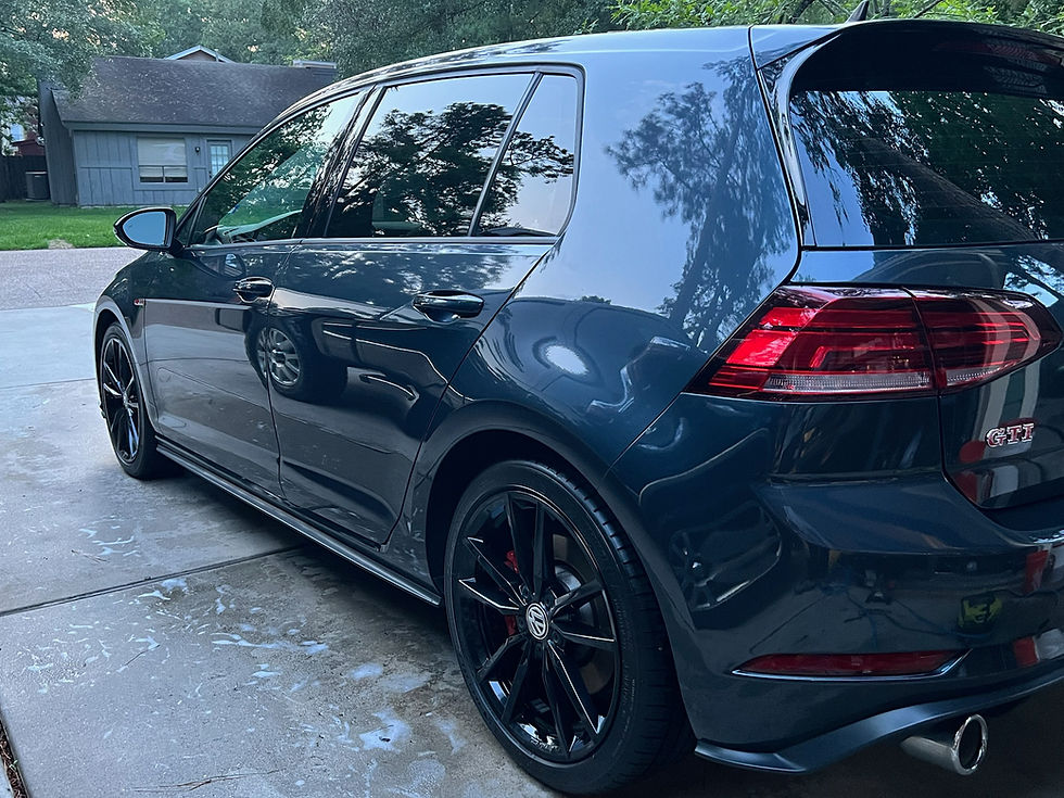 Dark blue Volkswagen GTI with clean, reflective paint and freshly detailed wheels
