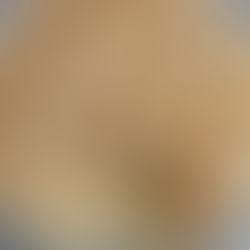 Clear glass bowl filled with off white banana pudding with vanilla wafer cookie crumbs and slices of bananas layered within and a large scoop taken out.