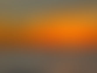 The alpenglow of a sunset at sea.