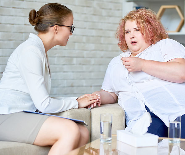 Healthcare professional holding hands with a woman during a supportive consultation—showcasing Trim MD Weight Loss Clinic’s c