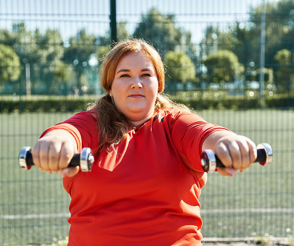 curvy-woman-joyfully-exercising-with-dumbbells-in-2024-08-21-01-22-48-utc.jpg