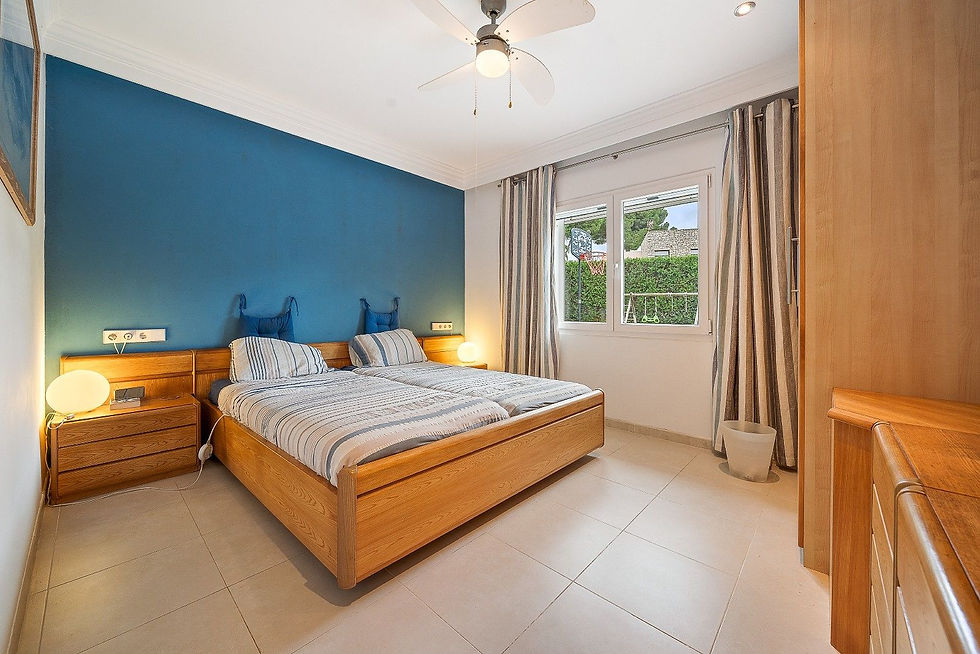 Bedroom with wooden headboard and blue accent wall, Costa de los Pinos villa