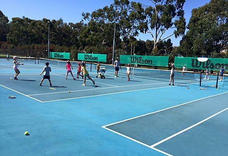 kids playing tennis games on tennis court