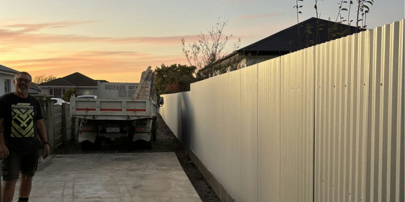 Allan Brookland with the finished fence project in Invercargill