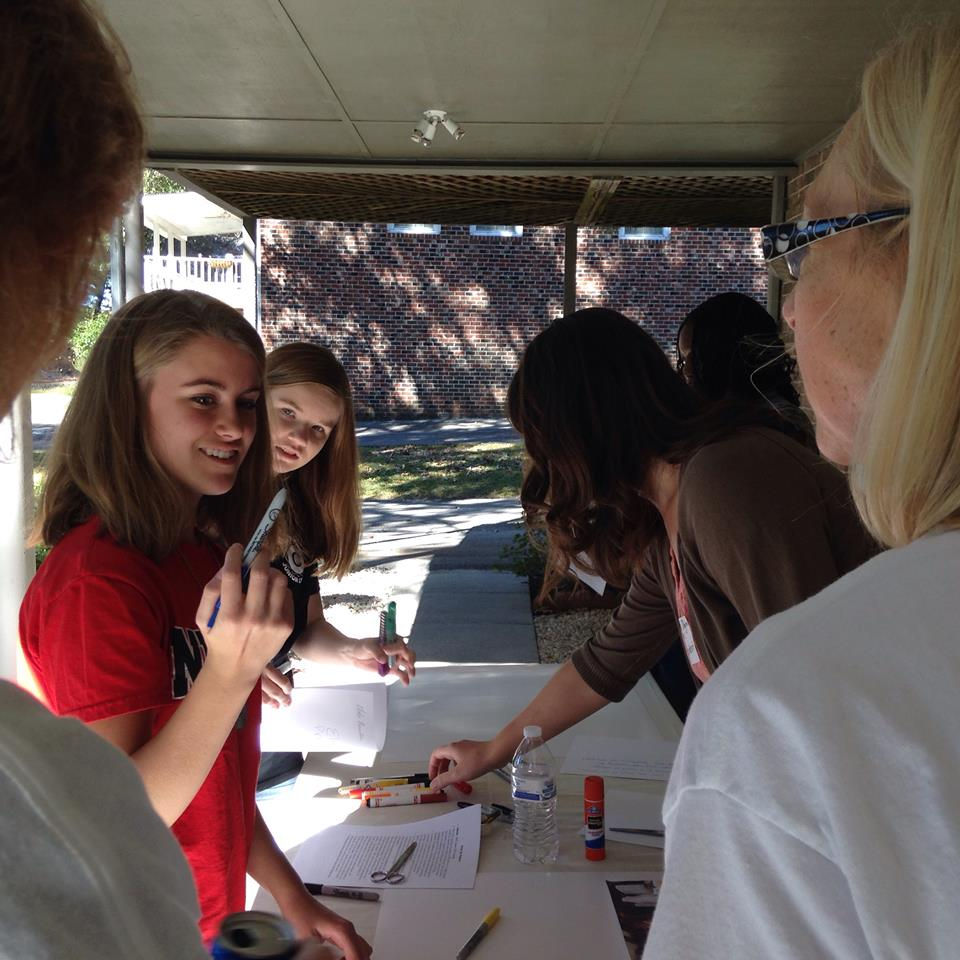 Creating posters for Ebola fundraising event.jpg