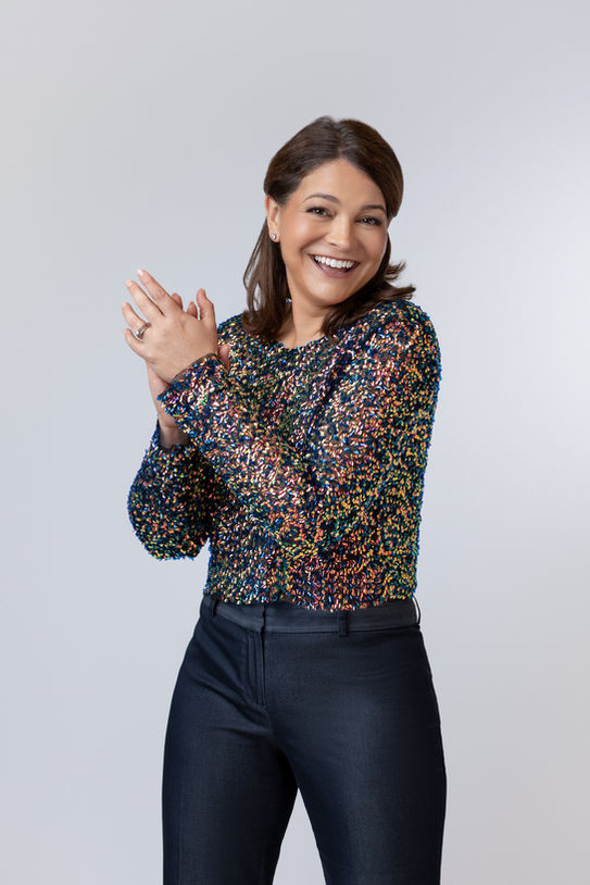 Woman clapping wearing sparkly shirt for personal branding photo