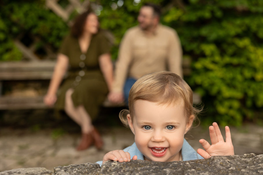 Girl smiling with parents behind