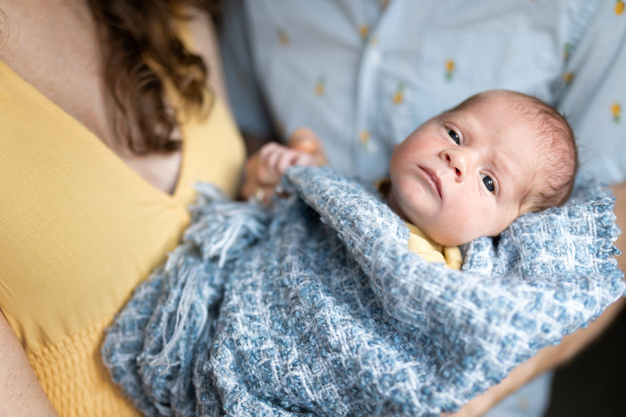 Mom and dad holding newborn son