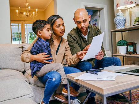 Multigeneral family reviewing financial paperwork