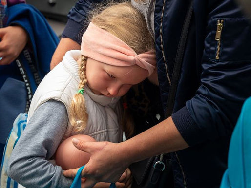 A five-year-old girl waits with her mother to board a bus to Poland from Zaporizhzhia in southern Ukraine.