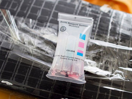 A package of cocaine seized by authorities along with a field test kit used to ascertain the substance. (file)