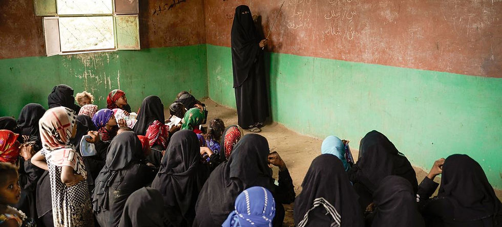 Displaced women and girls attend a class in Yemen
