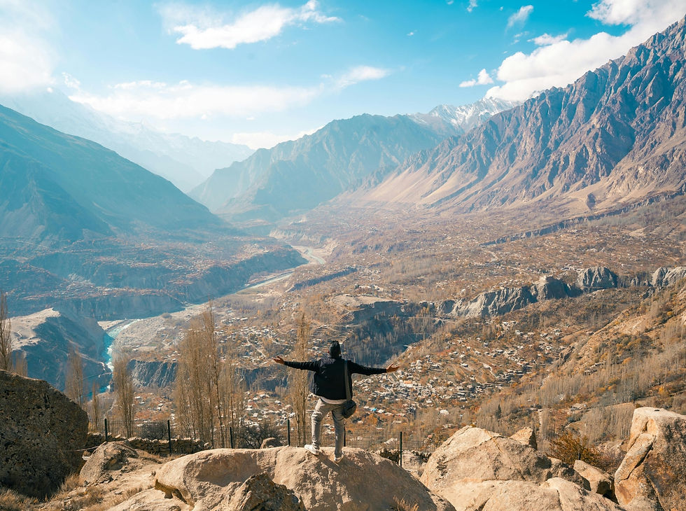 Trail runners crossing a suspension bridge in northern Pakistan during a Run Weekends Pakistan running adventure through the mountains of Gilgit-Baltistan