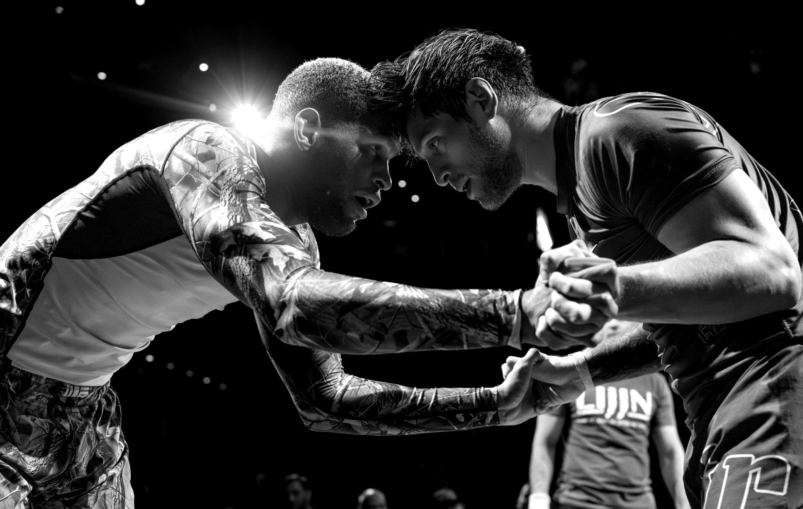 Dynamic jiu jitsu competitor performing a powerful takedown during a professional match