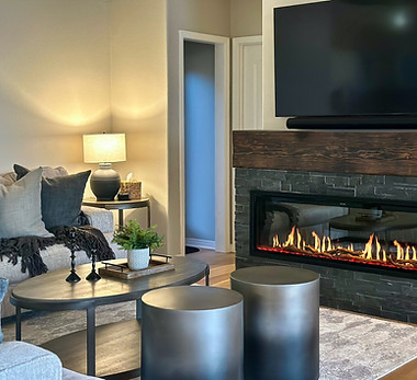 A modern living room with a glowing fireplace