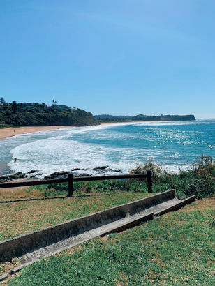Grassy area at the south end of Warriewood Beach, with the tranquil waters in the background, providing a peaceful coastal escape.
