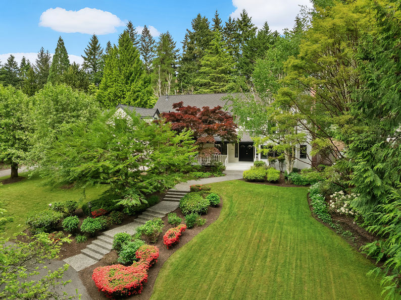Set on quiet Homewood Lane, a small community of 5 Bridle Trails estates, this idyllic country style retreat offers a perfect balance of privacy & convenience. New marble floors in the entry & refinished oak hardwoods flow through a generous main level, including a formal living room with gas fireplace framed by nature filled windows, a wood burning fireplace in the dining room, a dedicated office with custom built ins, & a warm family lounge. The chef's kitchen features Sub-Zero & Wolf appliances, quartz counters, white cabinetry, & a walk in pantry. Upstairs, discover 5 beds, including a primary suite with a private deck, updated 5-piece bath with soaking tub, & dual walk in closets. Back staircase leads you to a massive bonus room - a perfect place for games and entertainment. The crown jewel of this property is the sprawling backyard that feels like your own private park, with mature fruit trees (pear, apple, & blueberries), lush landscaping, & a large covered patio, perfect for entertaining or soaking in the serene surroundings. Updated water heater & A/C with dual heat pumps, updated backup gas furnace, security, wired for generator, oversized 850sf garage with EV charging. Highly sought after Cherry Crest Elementary.