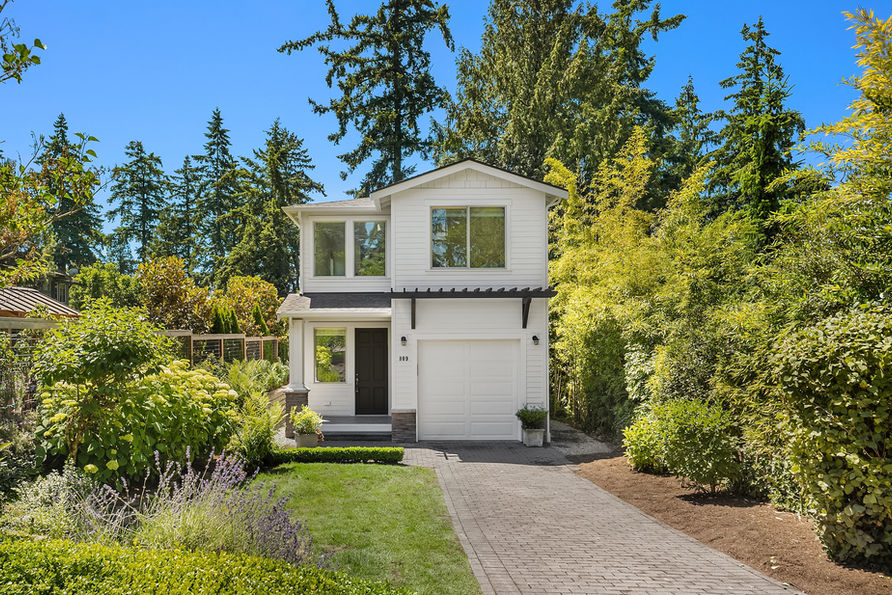 A highly sought after West of Market location, glimpses of Lake Washington, & a home that feels effortless. Tucked into a peaceful setting on a fully fenced and level lot; with brand new interior & exterior paint & new landscaping, this beautifully updated home is filled with natural light & thoughtfully designed spaces that connect seamlessly with the outdoors. Wake up to peek-a-boo lake views, spend evenings on the deck, & enjoy a home that feels both private & connected. A soaring vaulted entry welcomes you inside, where the main level unfolds across newly refinished hardwood floors to an open concept design. The kitchen features slab granite countertops, large island, gas cooktop, & stainless steel Fisher & Paykel appliances, flowing seamlessly into the dining room. The great room with gas fireplace connects the outside through French doors to an expansive entertaining deck & fully fenced backyard with mature landscaping. Upstairs, you will find 3 bedroom including a primary suite with vaulted ceilings, a private view deck, walk in closet, & an ensuite bath. 2 additional bedrooms, a full bath, as well as a utility room complete the upper level. Pella windows, custom Roman shade & new AC. Easy stroll to Downtown Kirkland, Kiwanis & Waverly Beach Park. 1 car attached garage with EV charging & plumbing for additional washer & dryer, lots of driveway & street parking. No HOA.