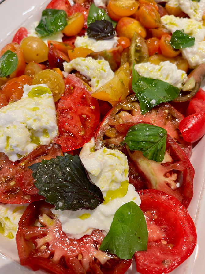 July is tomato season in Charleston, and it’s the perfect time to celebrate the beauty of peak produce. When I walk into the farmer's market or Veggie Bin on Spring Street downtown, I am inspired by all the produce options! This time of year, tomatoes are at their prime. Heirloom varieties, beef steak, cherry tomatoes, yellow tomatoes...the list goes on. Caprese salad, to me, is an opportunity to let tomatoes shine. I keep caprese salads simple with tomatoes cut into a variety of shapes, creamy buffalo mozzarella (I use the buffalo mozzarella cheese from goat.sheep.cow that they buy from Luigi Guffanti in Campania ), fresh basil, Olinda olive oil and flaky sea salt. It is so easy to make that you can do it with a glass of wine in your hands or hungry friends and family around you in the kitchen. Check out my five star caprese with mozzarella di Bufala