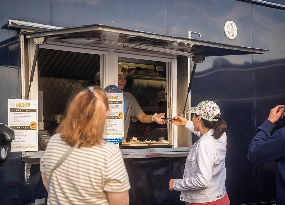 A woman ordering food from a food truck