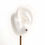 Thumbnail: Sterling silver skull stud earrings on white silicon ear.