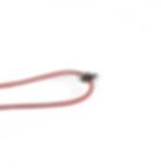 Small sterling silver hand pendant holding onto a red cord.