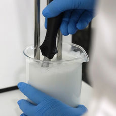 Science lab spatula mixing in a beaker