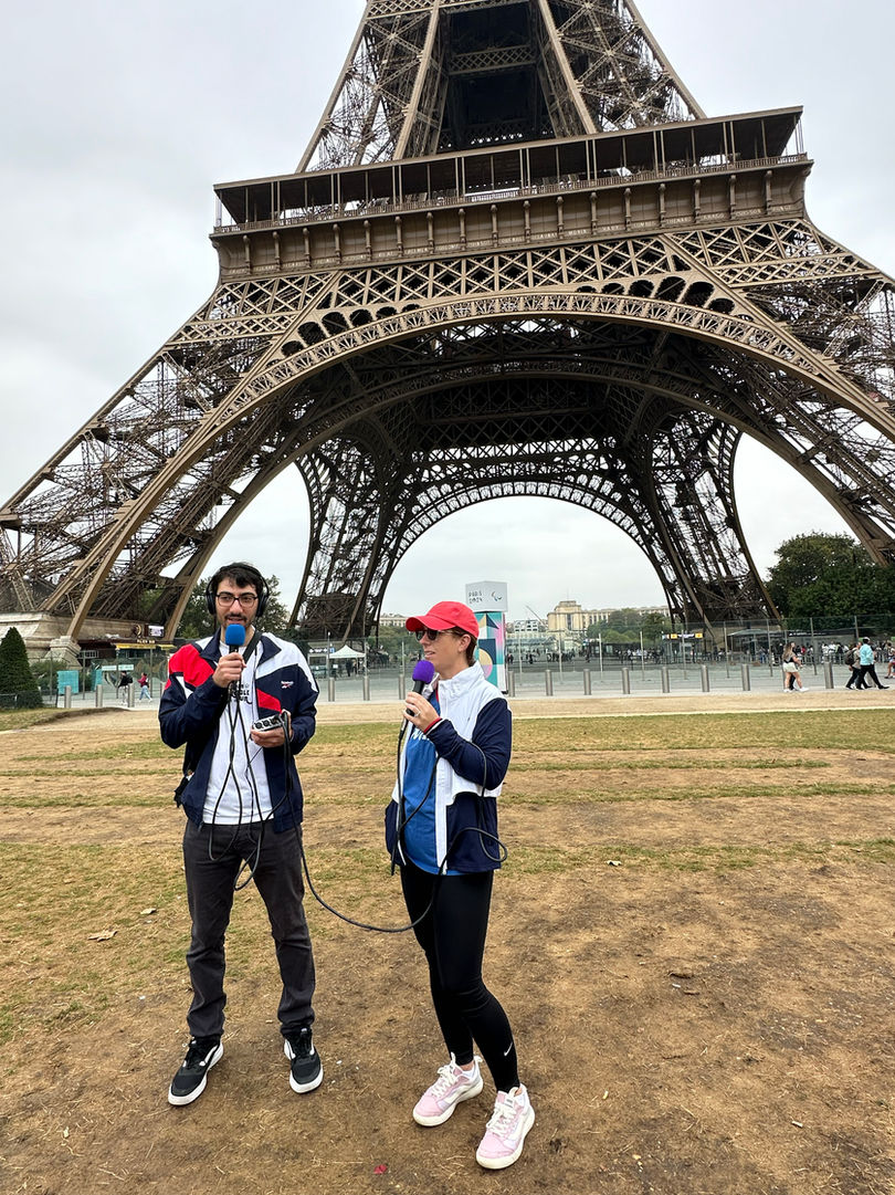 Erin and Mike podcast at the foot of the Eiffel Tower