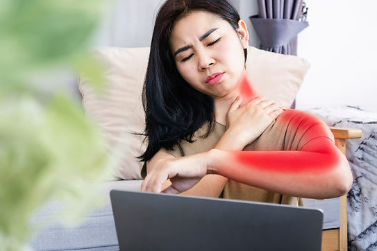 Asian woman suffering from neck pain spreading to shoulder and down arm caused by overwork