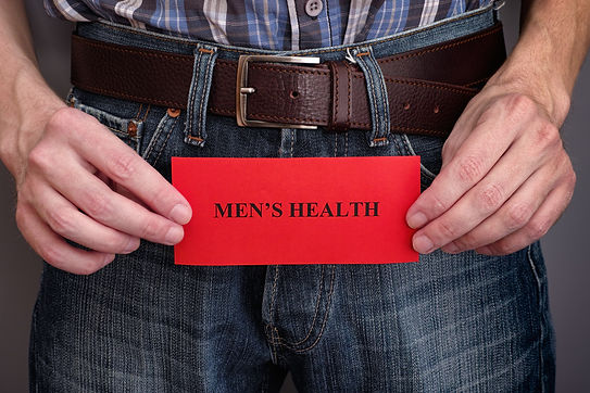 Men's health concept. Man holding red piece of paper with phrase Men'_s Health in his hand