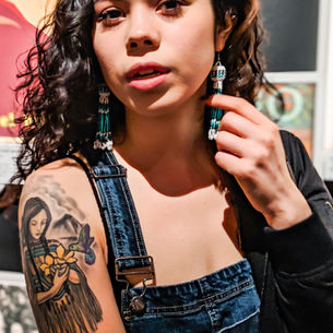 A young girl with a tattooed arm