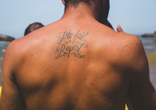 man with back tattoo out in the sun